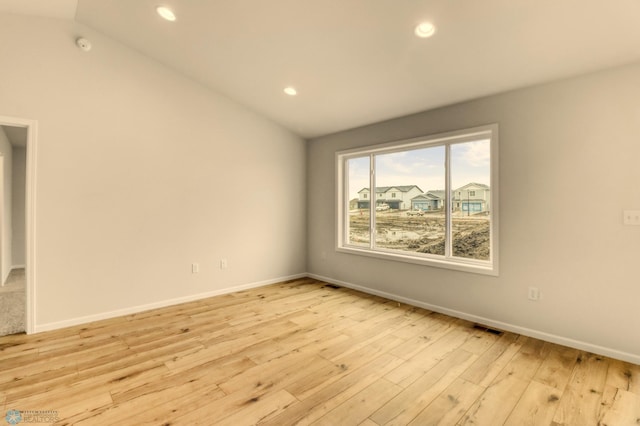 1474 66th Ave S, Fargo, ND 58104 - empty room featuring lofted ceiling, light wood finished floors, recessed lighting, and baseboards