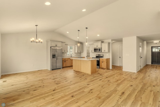 1474 66th Ave S, Fargo, ND 58104 - kitchen featuring stainless steel appliances, open floor plan, light countertops, light wood-style flooring, and lofted ceiling