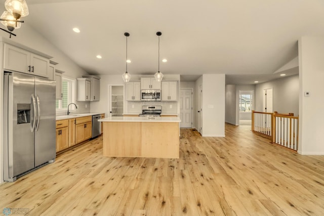 1474 66th Ave S, Fargo, ND 58104 - kitchen with appliances with stainless steel finishes, a sink, vaulted ceiling, light countertops, and recessed lighting