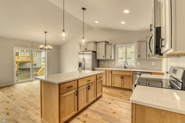 1474 66th Ave S, Fargo, ND 58104 - kitchen with stainless steel appliances, a sink, light wood-type flooring, lofted ceiling, and decorative backsplash