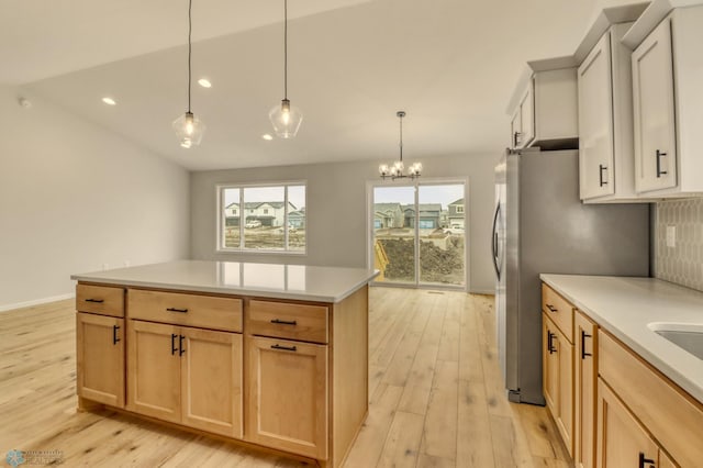 1474 66th Ave S, Fargo, ND 58104 - kitchen featuring light wood-type flooring, recessed lighting, light countertops, hanging light fixtures, and backsplash