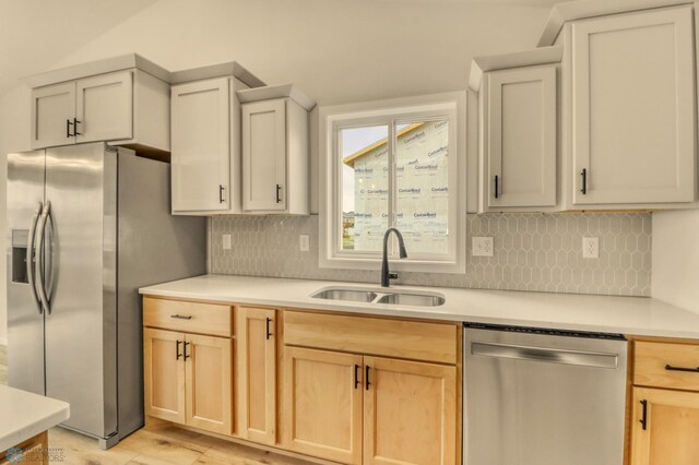 1474 66th Ave S, Fargo, ND 58104 - kitchen featuring appliances with stainless steel finishes, a sink, light brown cabinetry, and light countertops