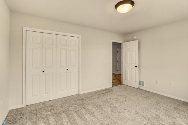 1474 66th Ave S, Fargo, ND 58104 - unfurnished bedroom with carpet flooring, a closet, and baseboards