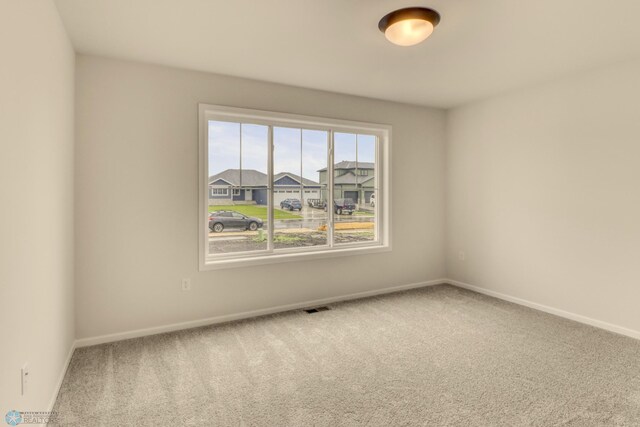 1474 66th Ave S, Fargo, ND 58104 - unfurnished room featuring carpet floors and baseboards