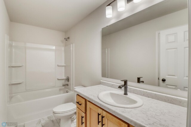 1474 66th Ave S, Fargo, ND 58104 - bathroom with vanity, toilet, marble look tile flooring, and shower / bathtub combination