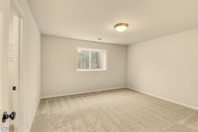 1474 66th Ave S, Fargo, ND 58104 - spare room featuring carpet floors and baseboards