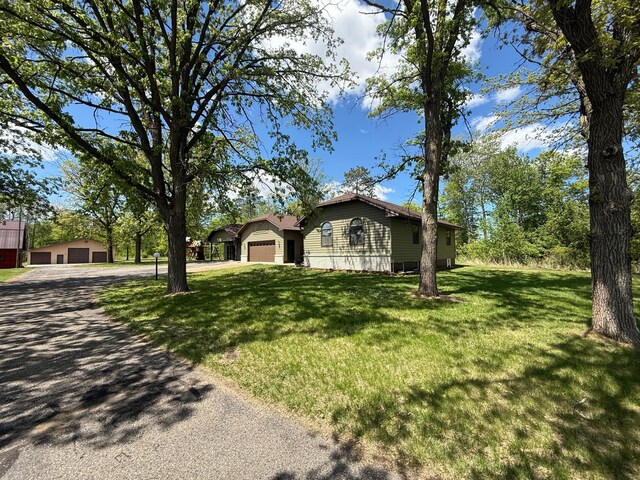 50429 245th Ave, Staples Twp, MN 56479 - view of front facade with driveway, a garage, a front yard, and an outdoor structure