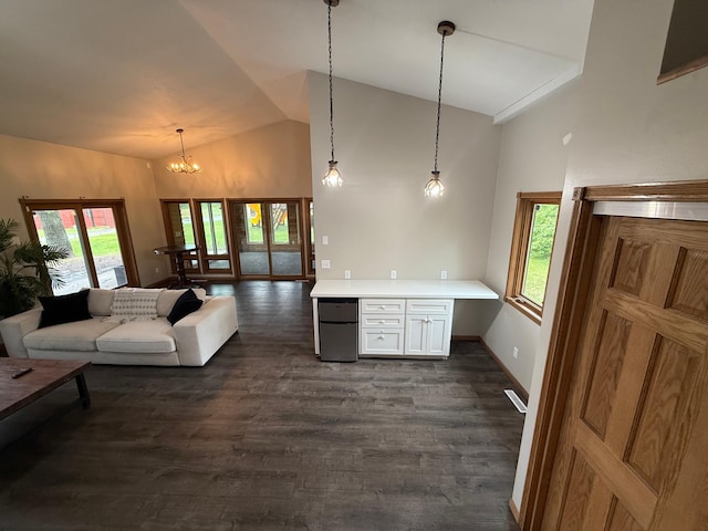 50429 245th Ave, Staples Twp, MN 56479 - living room featuring healthy amount of natural light, a chandelier, high vaulted ceiling, dark wood-style floors, and baseboards