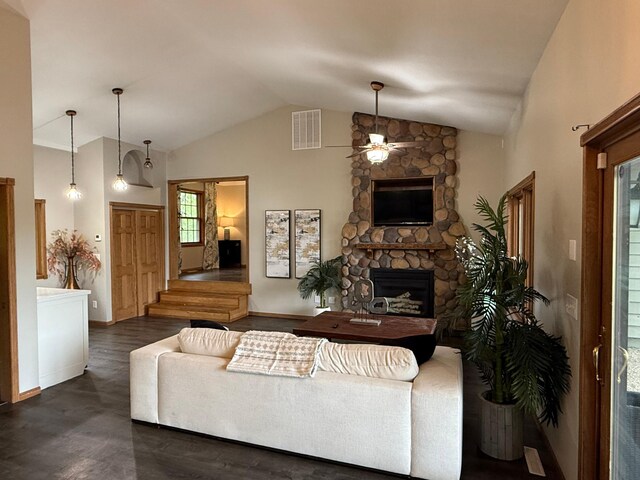 50429 245th Ave, Staples Twp, MN 56479 - living area with a ceiling fan, a stone fireplace, wood finished floors, baseboards, and high vaulted ceiling