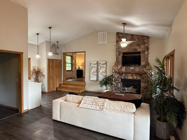 50429 245th Ave, Staples Twp, MN 56479 - living room with a ceiling fan, wood finished floors, a stone fireplace, baseboards, and high vaulted ceiling