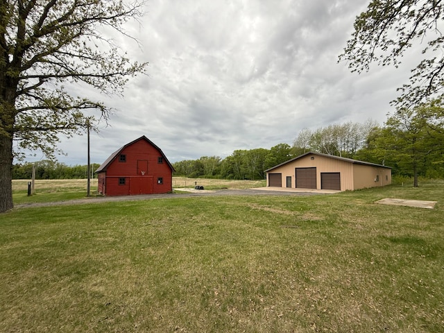 50429 245th Ave, Staples Twp, MN 56479 - view of green lawn with a garage, an outbuilding, and a barn