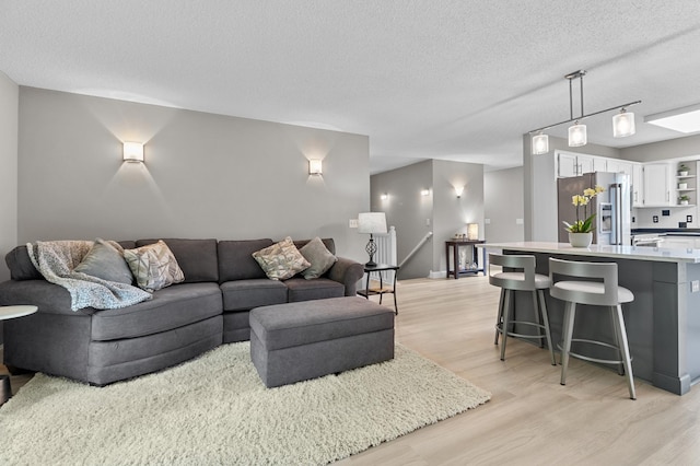 216 Crestview Cir, Jordan, MN 55352 - living room with light wood-style floors and a textured ceiling
