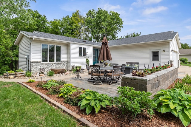 216 Crestview Cir, Jordan, MN 55352 - back of house featuring a patio, an attached garage, and brick siding