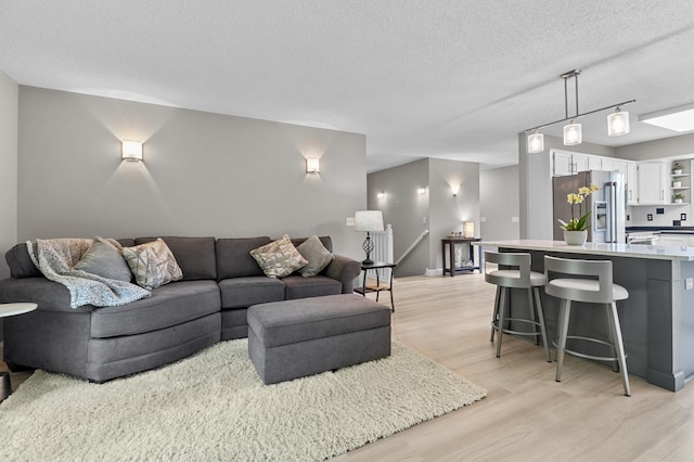 216 Crestview Cir, Jordan, MN 55352 - living area with a textured ceiling and light wood-type flooring