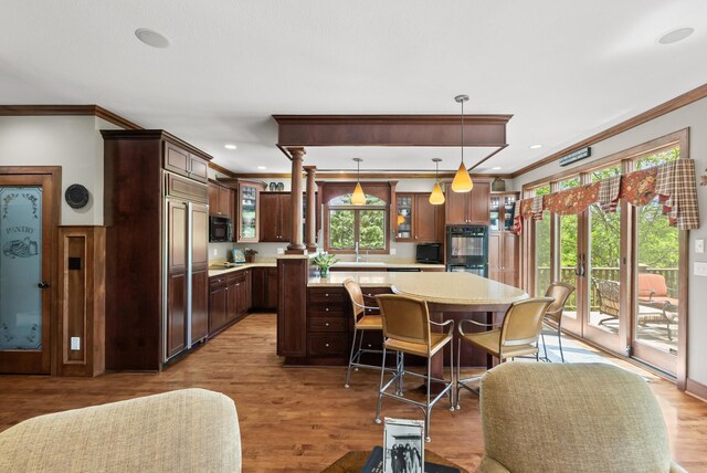 1595 River Shore Dr, Hastings, MN 55033 - kitchen with crown molding, light countertops, black appliances, a kitchen island, and glass insert cabinets