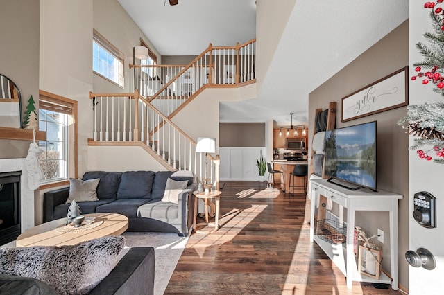 12828 43rd St NE, Saint Michael, MN 55376 - living area with dark wood finished floors, stairs, a high ceiling, and a fireplace
