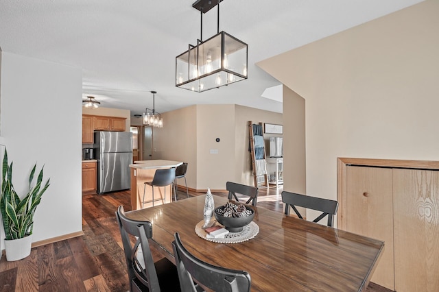 12828 43rd St NE, Saint Michael, MN 55376 - dining area with dark wood-style floors, a chandelier, and baseboards