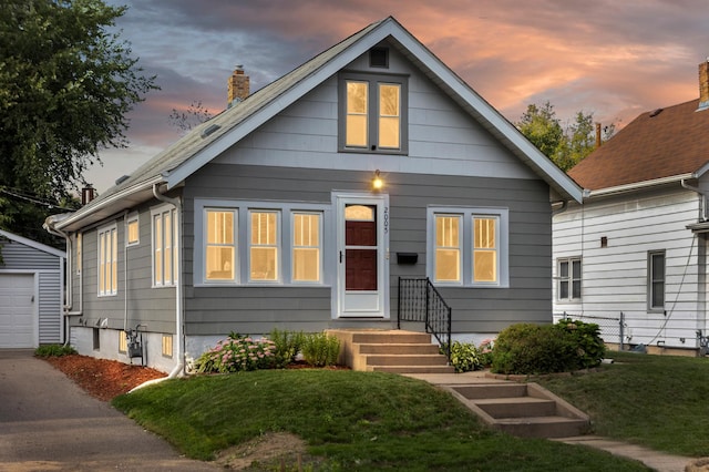 2005 Nokomis Ave, Saint Paul, MN 55119 - bungalow-style house with an outdoor structure, a yard, a chimney, and driveway