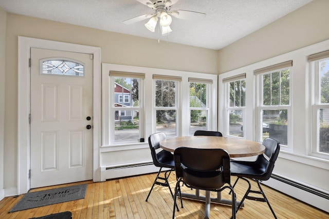 2005 Nokomis Ave, Saint Paul, MN 55119 - sunroom / solarium featuring a baseboard heating unit, hardwood / wood-style floors, healthy amount of natural light, and a textured ceiling