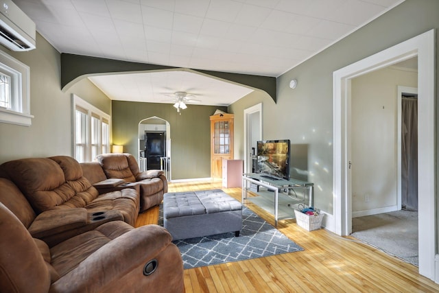 2005 Nokomis Ave, Saint Paul, MN 55119 - living room featuring arched walkways, an AC wall unit, a ceiling fan, and hardwood / wood-style floors