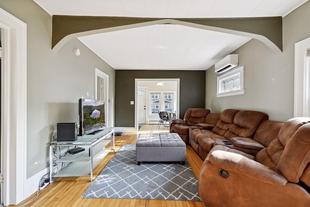 2005 Nokomis Ave, Saint Paul, MN 55119 - living room featuring a wall mounted air conditioner, hardwood / wood-style floors, arched walkways, and baseboards