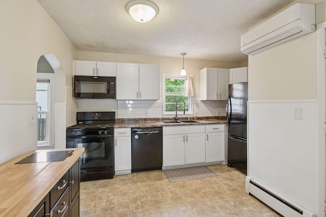 2005 Nokomis Ave, Saint Paul, MN 55119 - kitchen featuring black appliances, a sink, a baseboard heating unit, an AC wall unit, and wooden counters