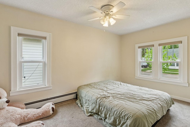 2005 Nokomis Ave, Saint Paul, MN 55119 - carpeted bedroom featuring a baseboard heating unit, a textured ceiling, baseboards, and ceiling fan