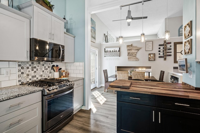 15657 Fish Point Rd SE, Prior Lake, MN 55372 - kitchen featuring appliances with stainless steel finishes, wood counters, tasteful backsplash, a ceiling fan, and dark wood finished floors