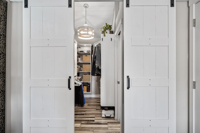 15657 Fish Point Rd SE, Prior Lake, MN 55372 - hallway with a barn door and wood finished floors