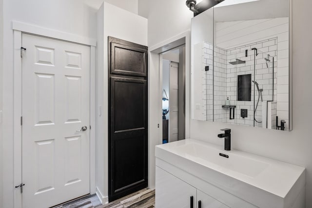 15657 Fish Point Rd SE, Prior Lake, MN 55372 - full bathroom featuring vanity, tiled shower, and wood finished floors