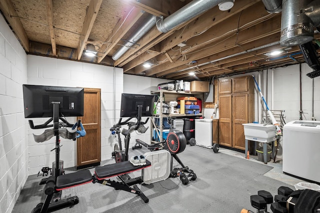 15657 Fish Point Rd SE, Prior Lake, MN 55372 - exercise area with washer / clothes dryer, concrete block wall, and a sink