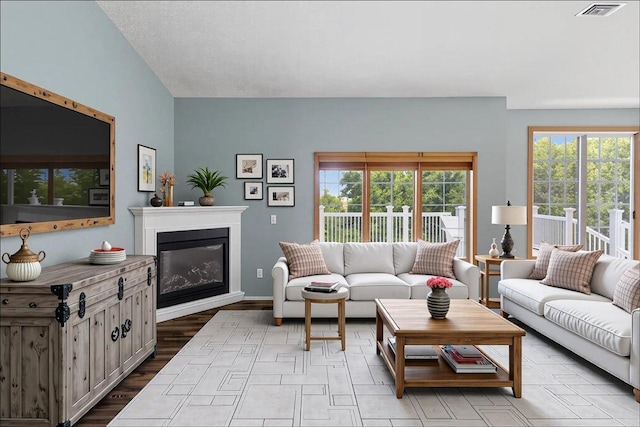 25809 Virgo St NE, Oxford Twp, MN 55079 - living area with a glass covered fireplace, wood finished floors, and baseboards