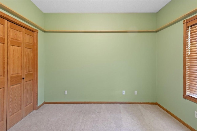 25809 Virgo St NE, Oxford Twp, MN 55079 - unfurnished bedroom featuring light colored carpet, baseboards, and a closet