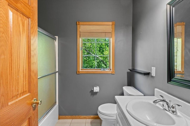 25809 Virgo St NE, Oxford Twp, MN 55079 - bathroom featuring toilet, tile patterned floors, baseboards, vanity, and combined bath / shower with glass door