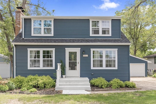 7537 Wentworth Ave, Richfield, MN 55423 - view of front of property with a chimney, a shingled roof, an outdoor structure, and a garage