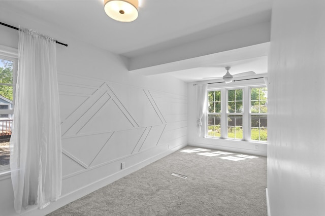 7537 Wentworth Ave, Richfield, MN 55423 - empty room with healthy amount of natural light, carpet, ceiling fan, and a decorative wall