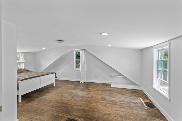 7537 Wentworth Ave, Richfield, MN 55423 - unfurnished bedroom featuring wood finished floors, baseboards, lofted ceiling, and recessed lighting