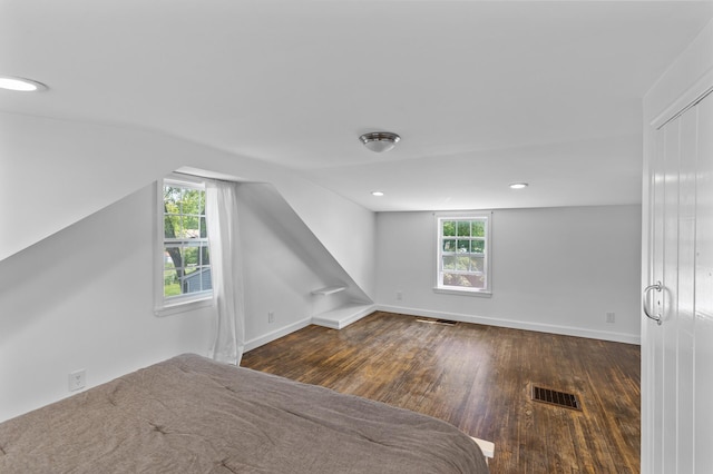 7537 Wentworth Ave, Richfield, MN 55423 - unfurnished bedroom with wood finished floors, multiple windows, and baseboards