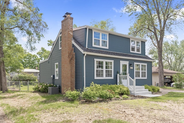 7537 Wentworth Ave, Richfield, MN 55423 - view of front of property with a chimney, central AC unit, and a shingled roof