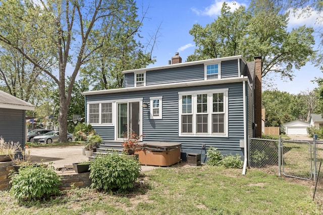 7537 Wentworth Ave, Richfield, MN 55423 - rear view of house featuring a hot tub, a chimney, and a gate