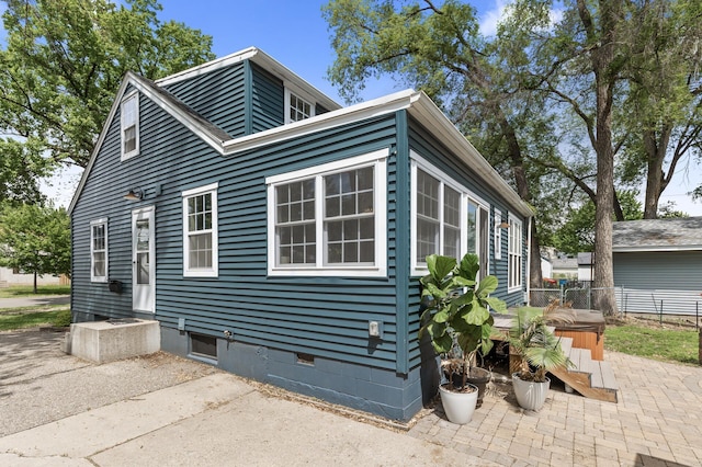 7537 Wentworth Ave, Richfield, MN 55423 - view of home's exterior with a hot tub, a patio area, and crawl space