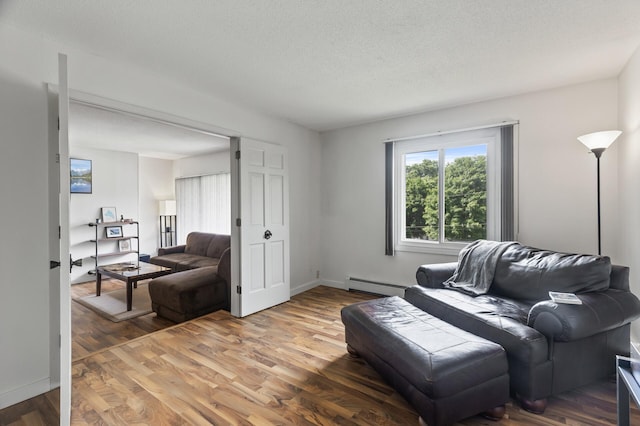 4207 Lakeside Ave N Unit 328, Brooklyn Center, MN 55429 - living area featuring a baseboard heating unit, light wood finished floors, a textured ceiling, and baseboards