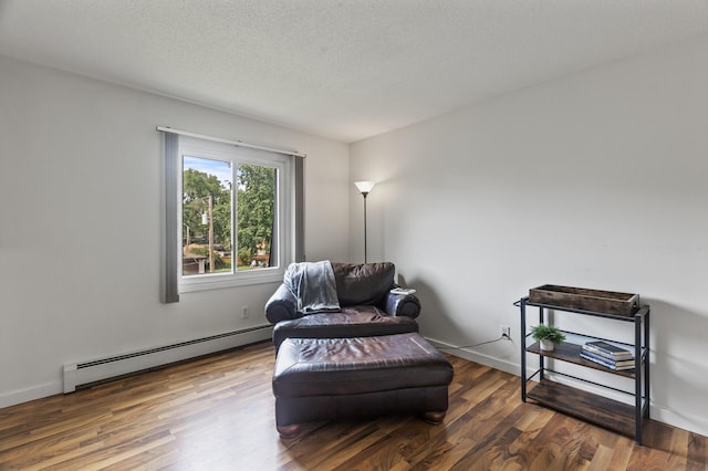 4207 Lakeside Ave N Unit 328, Brooklyn Center, MN 55429 - sitting room featuring baseboard heating, wood finished floors, a textured ceiling, and baseboards