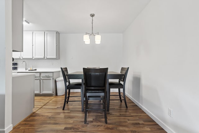 4207 Lakeside Ave N Unit 328, Brooklyn Center, MN 55429 - dining area featuring a chandelier, wood finished floors, and baseboards