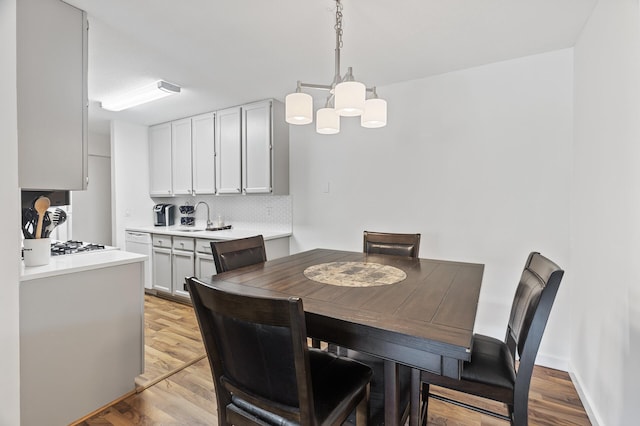 4207 Lakeside Ave N Unit 328, Brooklyn Center, MN 55429 - dining area featuring light wood-type flooring and a chandelier