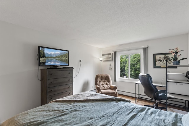 4207 Lakeside Ave N Unit 328, Brooklyn Center, MN 55429 - bedroom featuring wood finished floors, a textured ceiling, and a wall mounted air conditioner