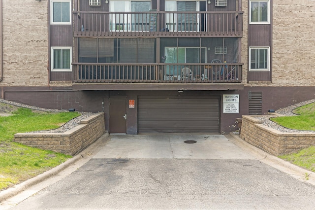 4207 Lakeside Ave N Unit 328, Brooklyn Center, MN 55429 - view of building exterior with an attached garage and asphalt driveway