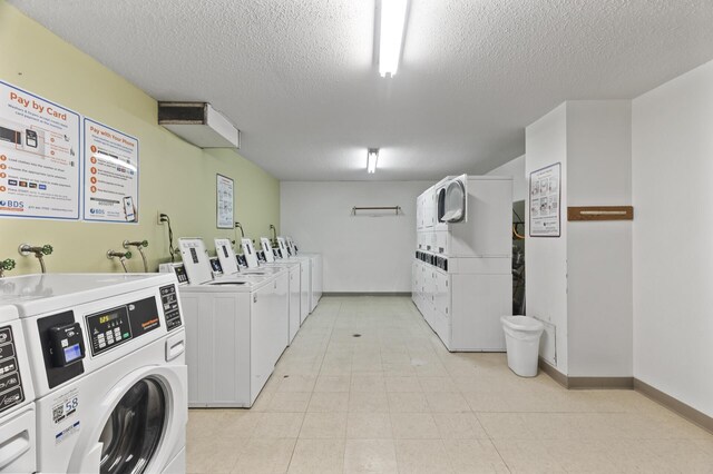 4207 Lakeside Ave N Unit 328, Brooklyn Center, MN 55429 - shared laundry with stacked washer and clothes dryer, separate washer and dryer, a textured ceiling, and baseboards