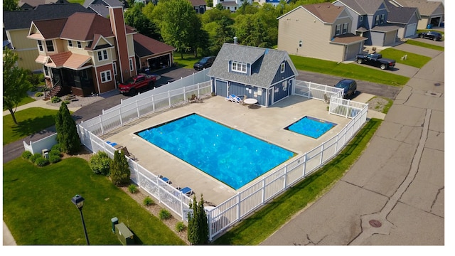 1756 34th St NE, Sauk Rapids, MN 56379 - view of swimming pool with an outdoor structure, a residential view, and a patio area