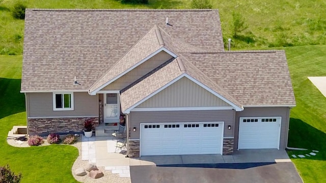 1756 34th St NE, Sauk Rapids, MN 56379 - view of front facade featuring stone siding, roof with shingles, a garage, driveway, and a front yard